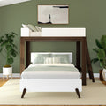 Modern loft bedroom with green walls, wooden and white bunk bed, and indoor plants.