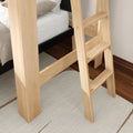 Close-up of light natural wood bunk bed ladder and frame with white mattress, textured rug and hardwood floor