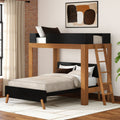 Modern wooden twin-over-full bunk bed with ladder and black accents in a bright contemporary bedroom with exposed brick wall, neutral bedding, and area rug
