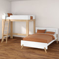 Modern minimalist children's bedroom with natural wood loft bed, white single bed and terracotta bedding on hardwood floor