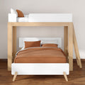 Modern wooden loft bunk bed with white frame, rust-brown bedding and ladder in minimalist bedroom on hardwood floor