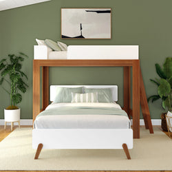 Modern green bedroom with loft bed and stylish decor, featuring wooden furniture and indoor plants.