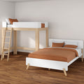 Modern minimalist bedroom featuring a wooden loft bed with ladder and a white single bed with orange bedding and pillows on hardwood floors.