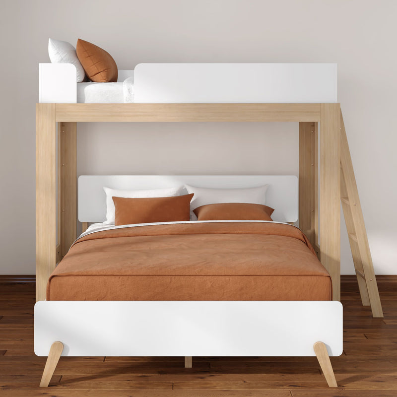 Modern wooden bunk bed with lower double bed and upper twin loft, white panels, rust-orange bedding and ladder on hardwood floor