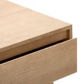 Close-up of light oak dresser drawer corner with natural wood grain, minimalist Scandinavian bedside table detail