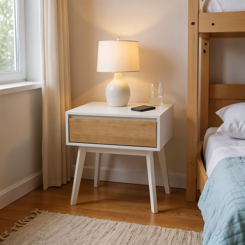 Stylish modern bedroom with a white nightstand, table lamp, and glass of water, enhancing home decor aesthetics.