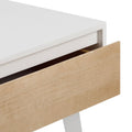 Modern white and natural wood desk corner with open drawer showcasing minimalist design.