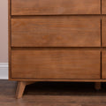 Close-up of mid-century modern solid wood dresser drawers with walnut finish and angled legs on hardwood floor, minimalist bedroom furniture