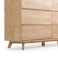 Modern wooden dresser with sleek drawers and minimalist design.