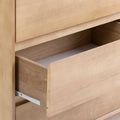 Open wooden dresser drawer showcasing smooth sliding mechanism in modern minimalist design.