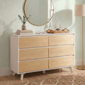Minimalist Scandinavian bedroom dresser with light wood drawers and white frame, round gold mirror, eucalyptus vase, woven tray and floor lamp