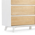 Modern wooden dresser with white frame and natural wood finish drawers, featuring sleek minimalist design.
