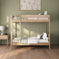 Wooden twin bunk bed with ladder in minimalist sage green bedroom, white bedding and bedside lamp
