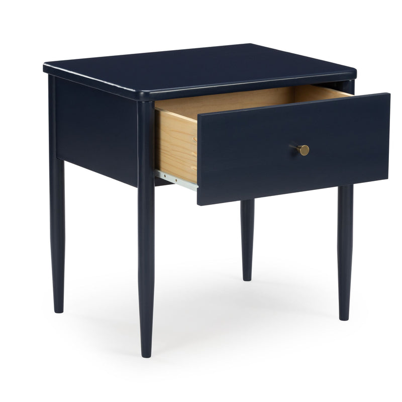 Navy blue nightstand with single open wooden drawer, brass knob and tapered legs on white background