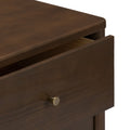 Close-up of slightly open dark brown wooden dresser drawer with brushed brass knob, modern bedroom furniture storage detail