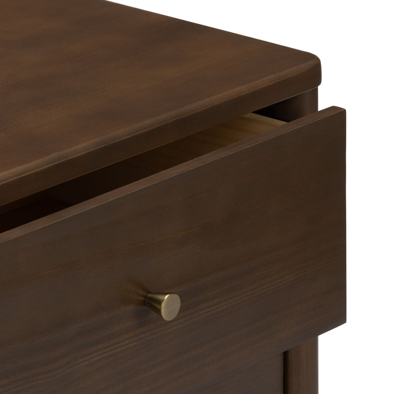 Close-up of slightly open dark brown wooden dresser drawer with brushed brass knob, modern bedroom furniture storage detail