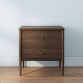 Mid-century modern walnut nightstand bedside table with two drawers, brass knobs and tapered legs on hardwood floor — minimalist bedroom furniture