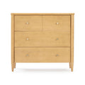 Mid-century modern light wood four-drawer dresser with tapered legs and round metal knobs on a white background