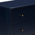 Close-up of navy blue dresser drawer with brass knob, modern matte-finish nightstand for bedroom storage