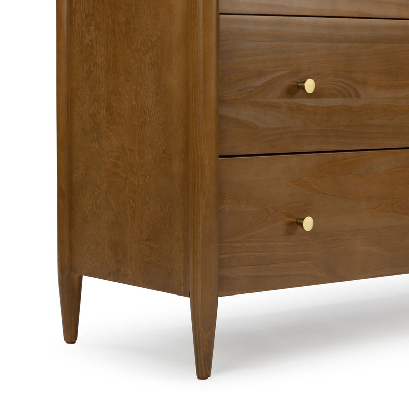 Mid-century modern walnut dresser close-up showing tapered legs, wood grain drawers and round brass knob