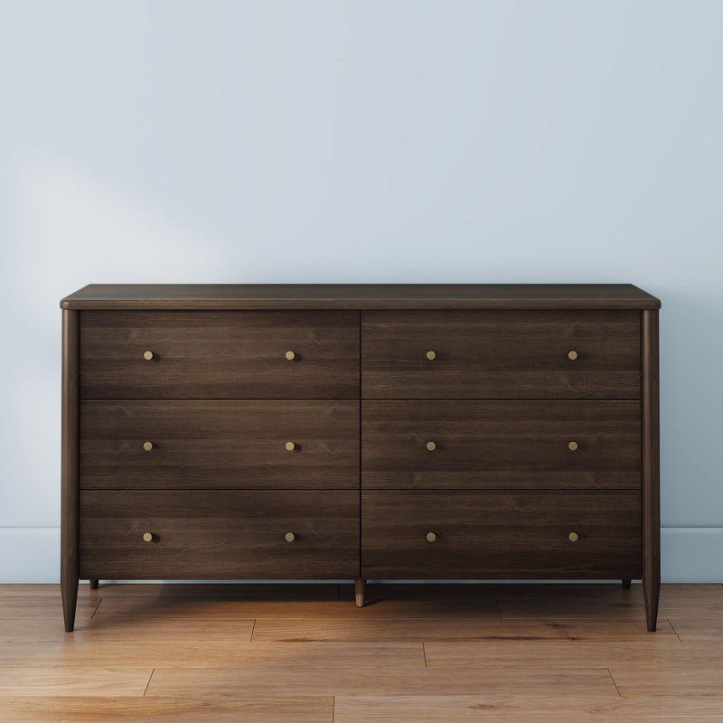 Mid-century modern dark walnut 6-drawer dresser with brass knob hardware on hardwood floor, bedroom storage furniture