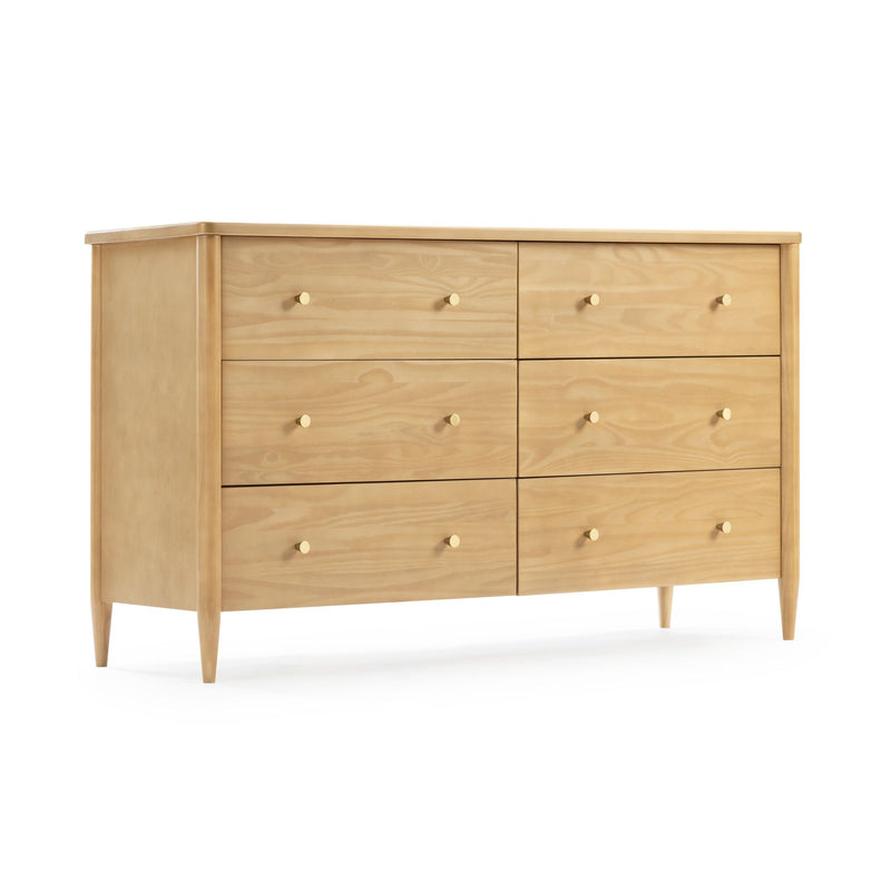 Mid-century modern light natural wood six-drawer dresser with round brass knobs and tapered legs on white background