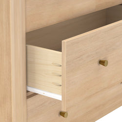Light wood dresser drawer open showing dovetail joints, brass knobs, white drawer slide and maple finish — modern minimalist wooden furniture close-up
