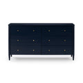 Navy blue six-drawer mid-century modern wood dresser with brass knobs on tapered legs, bedroom storage chest on white background