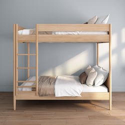 Natural oak twin-over-twin wooden bunk bed with ladder and neutral bedding in a minimalist Scandinavian-style bedroom