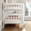 White wooden bunk bed in a modern bedroom with orange bedding, sheer curtains, large windows revealing a city skyline and hardwood floors