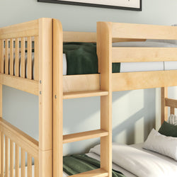 Close-up of natural maple solid wood bunk bed with built-in ladder and safety guardrail, white sheets and green blanket in modern kids' bedroom