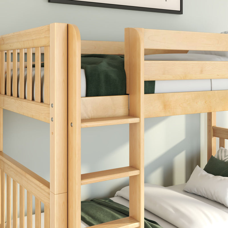 Close-up of natural maple solid wood bunk bed with built-in ladder and safety guardrail, white sheets and green blanket in modern kids' bedroom