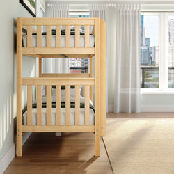Natural wood twin bunk bed in a bright modern bedroom with sheer curtains, hardwood floors and a city skyline view