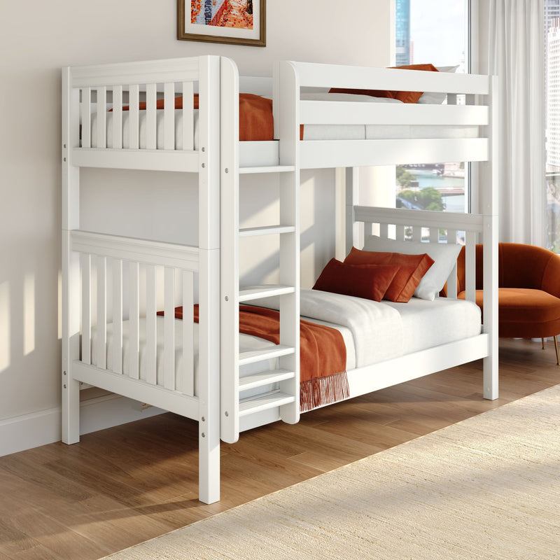 Modern white wooden bunk bed with ladder and safety rails, rust-orange bedding and pillows in a bright city apartment bedroom