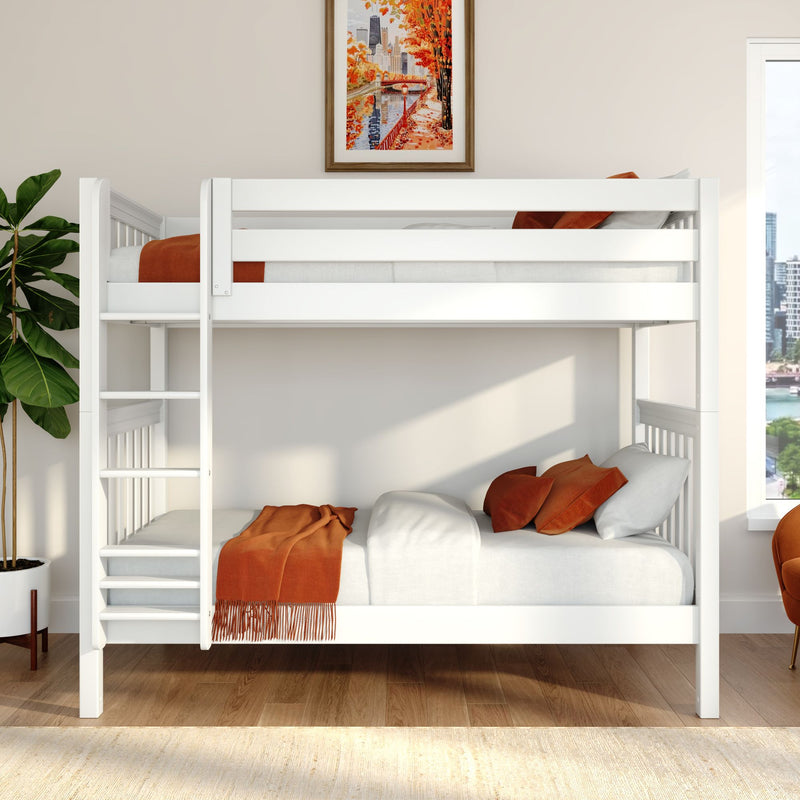 White wooden bunk bed in a modern kids' bedroom with orange throw blanket and pillows, framed autumn cityscape artwork, fiddle leaf fig plant, natural light and hardwood floor