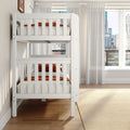 White wooden bunk bed with orange bedding in modern kids' bedroom, sheer curtains, hardwood floor and city skyline view