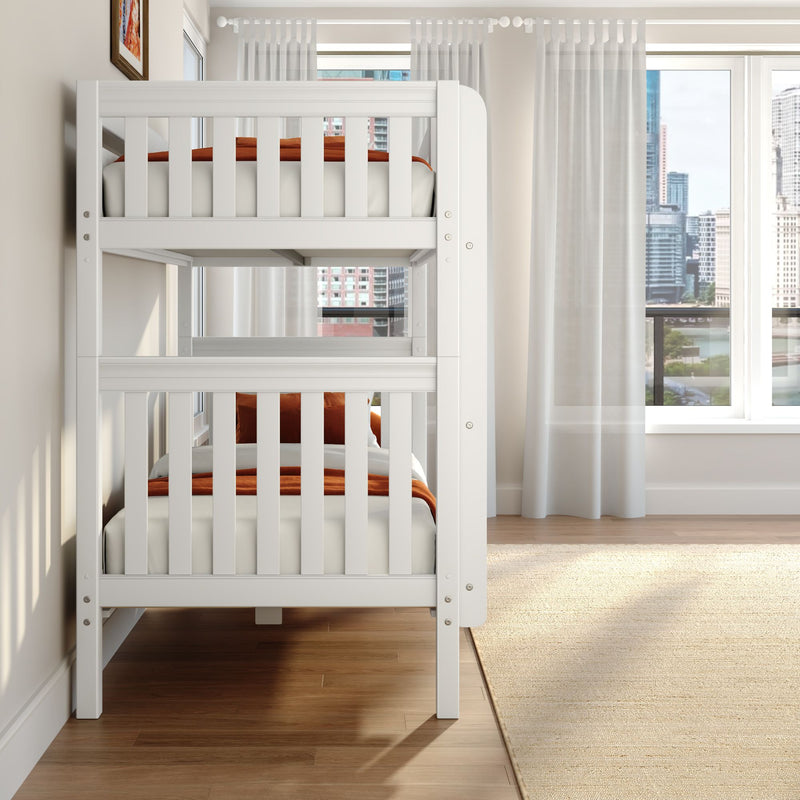 White wooden bunk bed with orange bedding in modern kids' bedroom, sheer curtains, hardwood floor and city skyline view