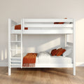 Modern white wooden bunk bed with orange throw and pillows in a minimalist kids' bedroom with neutral walls and hardwood floor