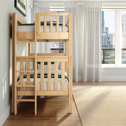 Natural wood bunk bed with green bedding in a bright minimalist bedroom by sheer curtains and a city skyline view