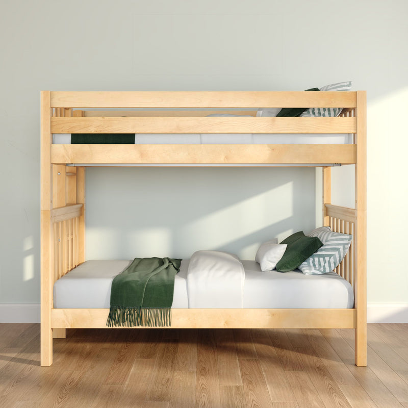 Light natural wood bunk bed with white linens, green throw and striped pillows on hardwood floor in a sunlit minimalist bedroom
