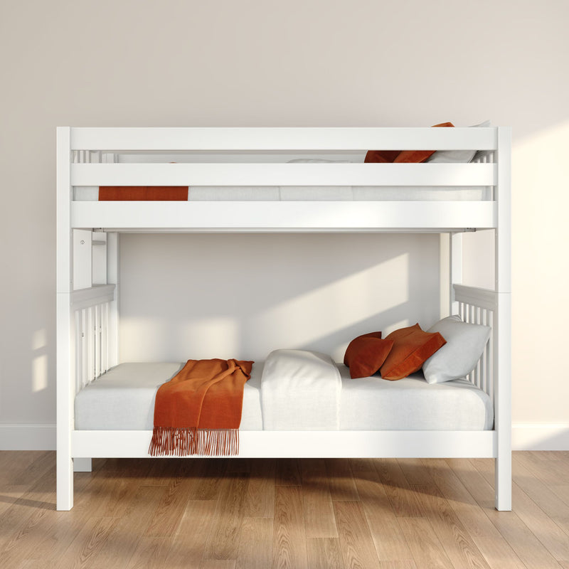 White wooden bunk bed with orange throw and pillows on hardwood floor in minimalist Scandinavian children's bedroom