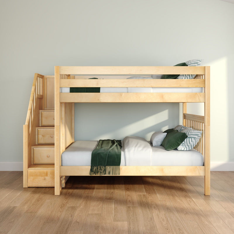 Light wooden space-saving bunk bed with staircase storage drawers and green bedding in a bright modern kids' bedroom