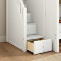 White built-in under-stair storage drawers with an open wooden drawer on oak floor — space-saving hallway organizer