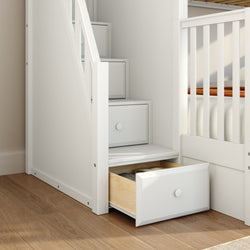 Space-saving white storage staircase with built-in drawers and slatted railing beside a loft bed on hardwood floor in a modern kids' bedroom