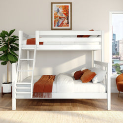 White wooden bunk bed with ladder, orange throw and pillows in a modern bedroom with framed autumn cityscape, fiddle leaf fig plant and city skyline window