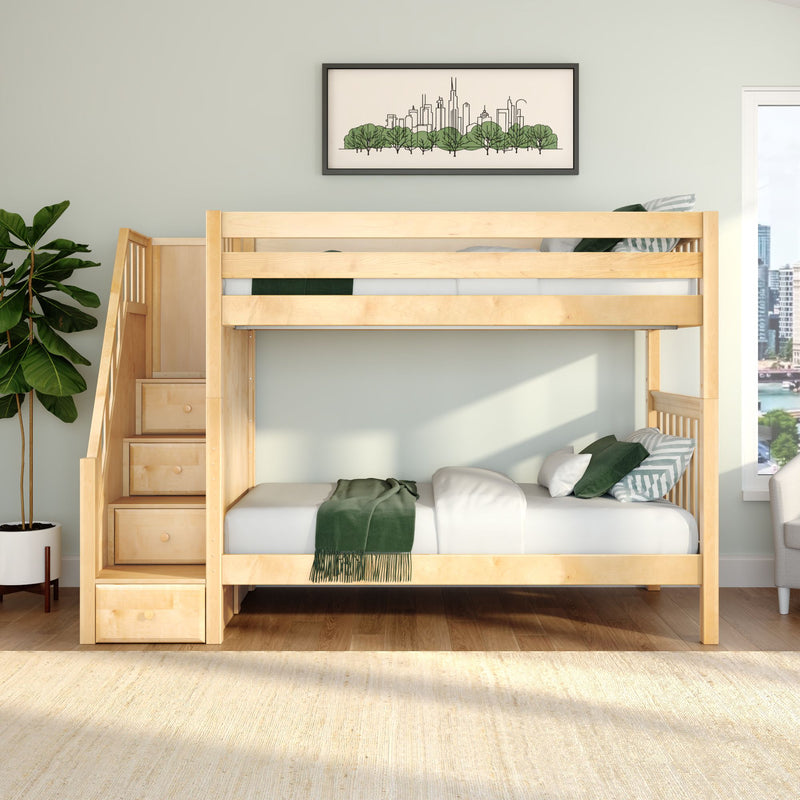 Modern natural wood bunk bed with staircase storage, green bedding and pillows in a bright kids' bedroom featuring a potted plant and framed city skyline art