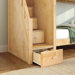 Light wood bunk bed with built-in storage drawers and staircase in modern bedroom