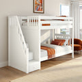 White loft bunk bed with built-in storage stairs and orange bedding in a sunlit modern kids' bedroom with city-view window