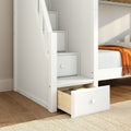 White wooden bunk bed with built-in stair drawers and orange throw in modern kids' room, space-saving storage solution