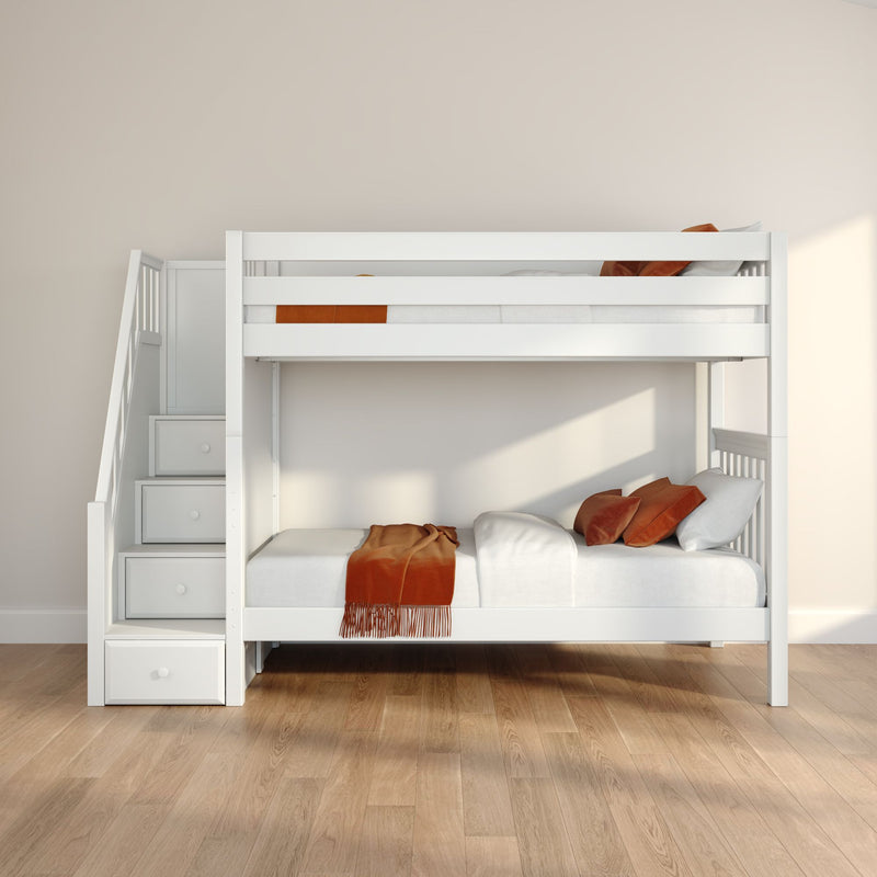 Modern white wooden bunk bed with staircase storage drawers, orange pillows and throw in a kids bedroom with beige walls and light wood floor